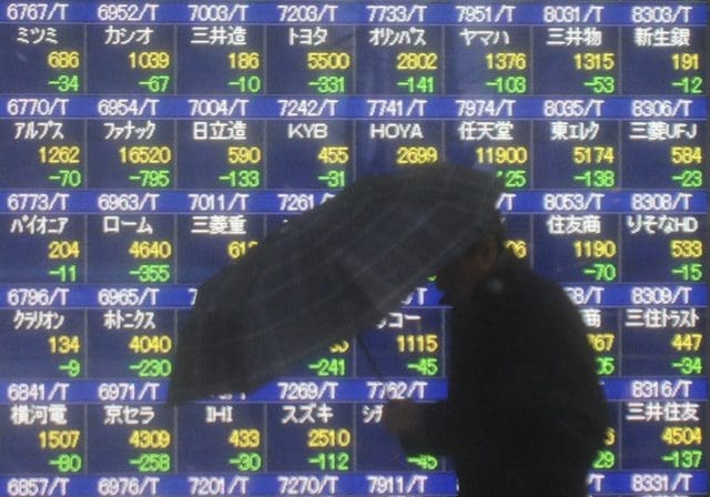 A man walks past an electronic board showing the stock index in Tokyo, Japan, Feb. 4, 2014. Tokyo stocks tumbled on Tuesday, with the Nikkei index ending 4.18 percent lower, hitting the lowest closing level since last October. The 225-issue Nikkei Stock Average dived 610.66 points, from Monday at 14,008.47, its lowest finish since Oct. 8. (Xinhua/Stringer)