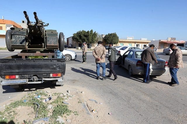 Libya Dawn fighters check passing cars near a local checkpoint in the al-Tusha area, west of al-Azizia, Libya, on April 3, 2015. Clashes continued in al-Azizia on Wednesday between pro-government forces and the Islamist armed coalition Libya Dawn. (Xinhua/Hamza Turkia)