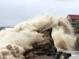 A strong wave breaks on shore ahead of the landfall of Typhoon Chan-Hom in Wenling in eastern China's Zhejiang province July 10, 2015. (Chinatopix Via AP)