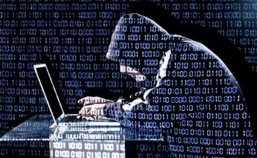 Hacker typing on a laptop Hacker typing on a laptop