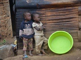 Children stand near a makeshift structure at Makerere trading centre in Zesui sub county, Sironko district, eastern Uganda, Nov. 23, 2015. With a steady population growth rate of 3.24%, the Uganda government is currently encouraging its population to practice family planning to avoid population explosion in the near future. The country has the second youngest population in the world.(Xinhua/Daniel Edyegu)
