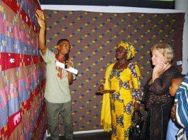 Mr Ahiagble Bob Dennis showing the various type of Kente to Madam Gomashie and the Norwegian Ambassador