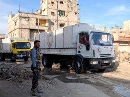 Aid trucks enter the rebel-held town of Douma, east of Damascus, Syria, on Feb. 13, 2016. The aid, delivered by the Syrian Arab Red Crescent(SARC), includes milk for kids, insulin, and other medicine for chronic diseases. (Xinhua/Ammar)