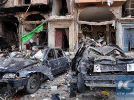 A picture taken on February 21, 2016 shows damaged cars at the site of a double car bomb attack in the Al-Zahraa neighborhood of the central Syrian city of Homs. (AFP photo)