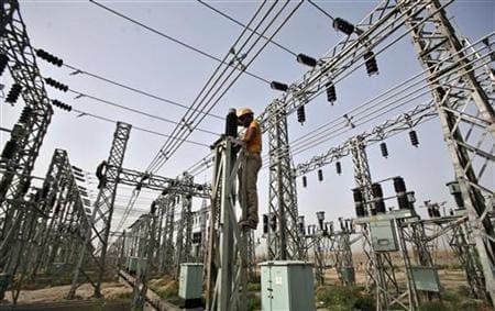 An employee works on electric pylons at a power station in Greater Noida An employee works on electric pylons at a power station in Greater Noida on the outskirts of New Delhi June 8, 2012. REUTERS/Parivartan Sharma/Files