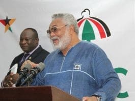 Former President Jerry John Rawlings (1st R) congratulating an NDC founding member