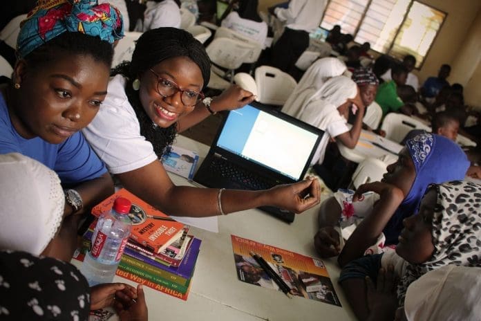 Volunteers train students on using digital literacy tools