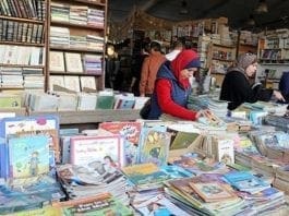 People browse through books on a stand at the Cairo International Book Fair, in Cairo - Reuters