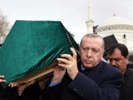 Turkey's President Recep Tayyip Erdogan carries a coffin as he joins hundreds of mourners who attend the funeral prayers for nine members of Alemdar family killed in a collapsed apartment building in Istanbul. AP