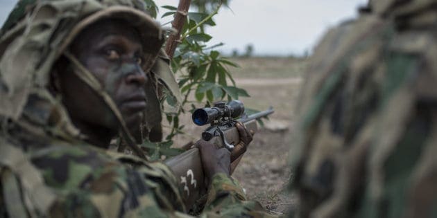 TOPSHOT-NIGERIA-AFRICA-DEFENCE-MILITARY TOPSHOT - A member of the Nigerian Armed Forces Sniper Unit wearing a ghillie suit takes part in an exercise during the African Land Forces Summit (ALFS) military demonstration held at General Ao Azazi barracks in Gwagwalada on April 17, 2018. - The African Land Forces Summit (ALFS) is a weeklong seminar held in Nigeria, bringing together land forces from across Africa to discuss and develop cooperative solutions and improve transregional security and stability. (Photo by STEFAN HEUNIS / AFP) (Photo credit should read STEFAN HEUNIS/AFP/Getty Images)