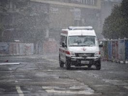 An ambulance drives on the street of Xiaogan, central China's Hubei Province, Feb. 15, 2020. Xiaogan witnessed a snowfall on Saturday as people around the city still fight in the battle against the novel coronavirus. (Xinhua/Hu Huhu)