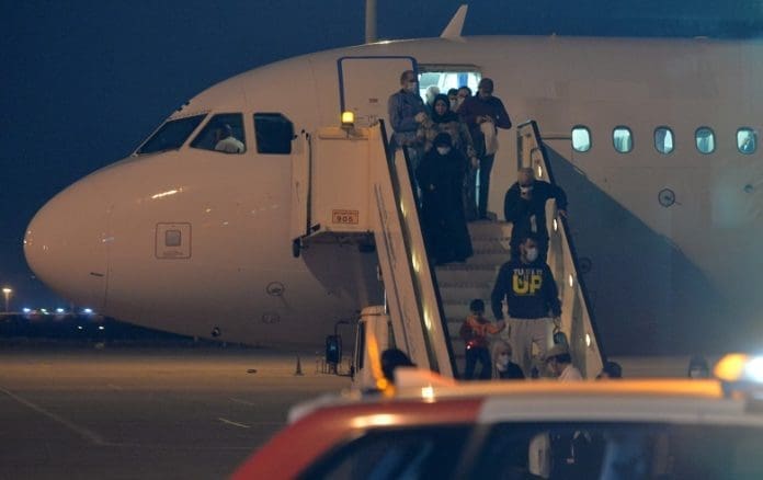 Kuwaiti nationals evacuated from Iran get off a plane at Kuwait International Airport in Farwaniya Governorate, Kuwait, Feb. 22, 2020. Kuwait received the arrival of the first flight from Iran with Kuwaiti nationals on Saturday, as part of the country's evacuation plan after the COVID-19 outbreak in Iran. (Photo by Asad/Xinhua)