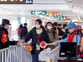 Photo taken on Feb. 2, 2020 shows policemen, medical staff and volunteers take passengers' body temperature and check identity information to prevent and control epidemic at the exit of a railway station in Changzhou, east China’s Jiangsu province, where the passenger traffic increased gradually. Chen Wei/People’s Daily Online