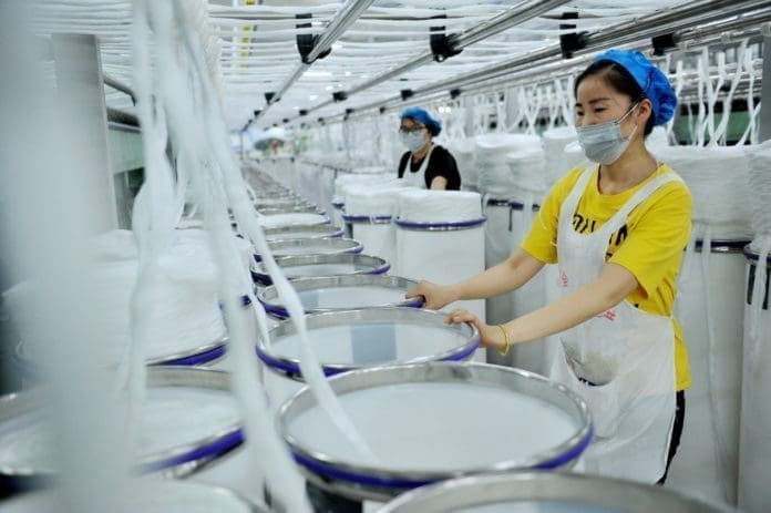 Employees work at a textile workshop in Yushan county, east China’s Jiangxi province, April 12, 2020. Photo by Zhuo Zhongwei, People’s Daily Online