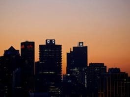 FILE PHOTO: The buildings with the logos of three of South Africa's biggest banks, ABSA, Standard Bank and First National Bank (FNB) are seen against the city skyline in Cape Town, South Africa, September 3, 2017.REUTERS/Mike Hutchings/File Photo