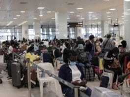 Ghanaian evacuees from Lebanon going through immigration checks at the Kotoka international Airport in Accra