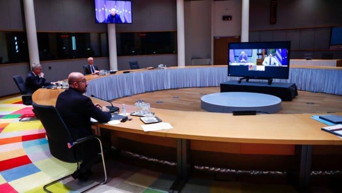 European Council President Charles Michel, left, talks during a video conference with the leaders of Germany, France, Portugal and Greece, on the screen, ahead of the EU summit at the European Council headquarters in Brussels, Tuesday, March 23, 2021. (AP Photo/Francisco Seco, Pool)