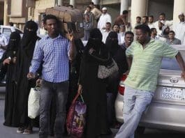 FILE PHOTO: An Ethiopian worker carries his suitcase, as he waits along with his countrymen to be repatriated, in Manfouha, southern Riyadh, Saudi Arabia on November 10, 2013. REUTERS/Faisal Al Nasser