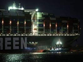 27 March 2021, Egypt, Suez: A general view of "Ever Given", a container ship operated by the Evergreen Marine Corporation which is currently stuck in the Suez canal, during a tugging attempt to re-float it. The state-run Suez Canal Authority (SCA) announced that nearly 17,000 cubic meters of sand have been dredged around the ship after navigation through the Suez Canal has been temporarily suspended until the full refloating of the Panamanian massive cargo vessel which ran aground on Tuesday in the southern end of the Suez Canal and blocked the traffic in both directions. The ship turned sideways in the Canal, while on the route from China to Rotterdam, due to reduced visibility that resulted from a dust storm hitting the area, according to SCA. Photo: Fadell Dawod/dpa