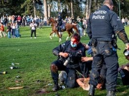 01 April 2021, Belgium, Brussels: An injured policeman arrests a protester at the Bois de La Cambre - Ter Kamerenbos as Brussels local police start the evacuation of the Park. Photo: Hatim Kaghat/BELGA/dpa