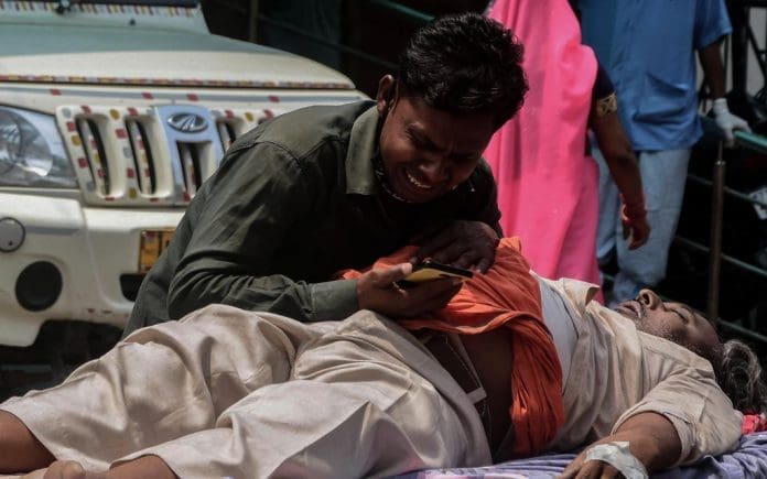 02 May 2021, India, Prayagraj: A man grieves near a relative suffering from coronavirus complications while waiting for admission at the Swaroop Rani Neharu hospital amid shortage in hospital beds and medical oxygen. Photo: Prabhat Kumar Verma/ZUMA Wire/dpa