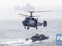 Russian navy ships and a helicopter take a part in a landing operation during military drills at the Black Sea coast, Crimea, Sept. 9, 2016. (AP Photo)