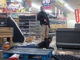 A police officer detains a suspect looting a shop in Johannesburg, South Africa, on July 12, 2021. Soldiers have been deployed in KwaZulu-Natal and Gauteng provinces to deal with violent protests and looting, the South African army said on Monday. Police said six people were killed and 219 people arrested over the weekend in Gauteng and KwaZulu-Natal following violent protests after former president Jacob Zuma was jailed for 15 months for contempt of court. Hundreds of shops and businesses across the two provinces were looted. (Photo by Yeshiel/Xinhua)
