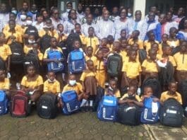 Ms. Larsen making presentation to one of the pupils (above) and pupils with GNAT officials (middle) and beneficiary pupils (below)
