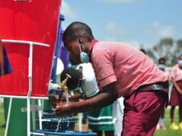 Students demonstrate handwashing with soap and water at the event Photo: Lawrence Quarcoo/CRS