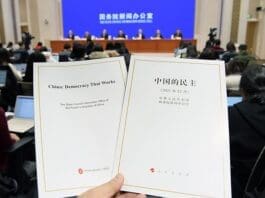 Photo taken on Dec. 4 shows the Chinese and English editions of the white paper titled “China: Democracy That Works” issued by China’s State Council Information Office during a press conference. (Photo/Official website of China’s State Council Information Office)