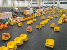 Workers assign parcels to robots at the logistics center of Fast Fish, a fast fashion retailer, in a smart logistics park in Deqing county, Huzhou city, east China’s Zhejiang province, Jan. 4, 2022. (Photo by Wang Shucheng/People’s Daily Online)