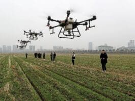 Technicians of an agricultural cooperative in Quanjiao county, Chuzhou, east China's Anhui province test agricultural drones, Feb. 12, 2022. (Photo by Shen Guo/People's Daily)