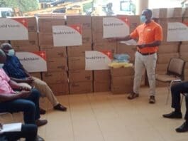 Mr Richard Okai, Integrated Programmes Director at World Vision Ghana, presenting medical items to health directorates