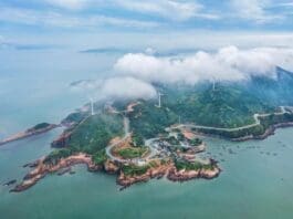 Photo taken on June 15, 2022 shows a country road winding along the coastline in Xiapu county, Ningde city, southeast China's Fujian province. (Photo by Zheng Peiluan/People's Daily Online)