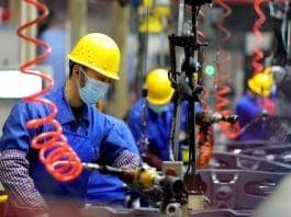 Workers produce products bound for the North America in a workshop of Anqing Heli Axle Co., Ltd., Dec. 9, 2022. (Photo by Jiang Sheng/People's Daily Online)