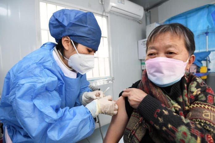 A medical worker injects the COVID-19 vaccine for a resident in Guiyang, southwest China's Guizhou province, Dec. 9, 2022. (Photo by Zhao Song/People's Daily Online)
