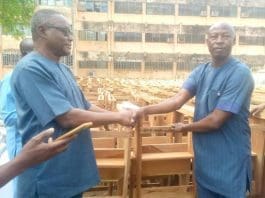 Photo showing Mr Martin Ayamga (right) presenting the furniture to Mr Rex Asanga (left)