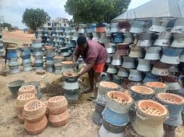 A Worker Busily Producing The Cookstoves