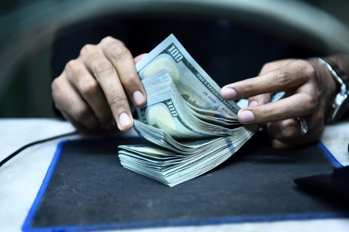 A teller counts U.S. dollar banknotes in Karachi, southern Pakistan, on Dec. 14, 2022. Pakistan's Federal Board of Revenue (FBR) has fixed a limit of 5,000 U.S. dollars per visit for all passengers 18 years old and above traveling abroad, local media reported on Wednesday. (Str/Xinhua) A teller counts U.S. dollar banknotes in Karachi, southern Pakistan, on Dec. 14, 2022. Pakistan's Federal Board of Revenue (FBR) has fixed a limit of 5,000 U.S. dollars per visit for all passengers 18 years old and above traveling abroad, local media reported on Wednesday. (Str/Xinhua)