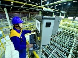 A technician checks the production of a full-automated production line in a factory of a construction materials company in Taicang, east China's Jiangsu province. (Photo by Ji Haixin/People's Daily Online)