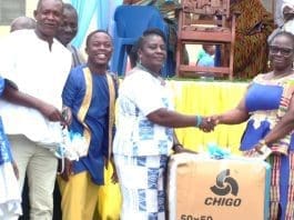 Headmistress of Three Town SHS, Denu, Ms. Akosua Dzifa Seshie (right), presenting the Most Dedicated Non-Teaching Staff Member Award to Ms. Love Sekpe