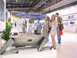 The 6th Western China International Fair for Investment and Trade kicked off on May 23, 2024 in southwest China's Chongqing municipality. Photo shows foreign visitors looking at an explosion-proof four-legged robot at an exhibition stand. (Photo by Wang Jiaxi/People's Daily Online)