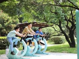 Tourists ride stationary bikes that generate electricity on the Juzizhou Islet in Changsha, central China's Hunan province. (Photo by Lin Daohui/People's Daily Online)