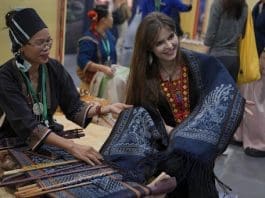 A Russian woman marvels at traditional Li textile techniques at the 2024 (4th) Hainan Brocade and Embroidery World Culture Week held in south China's Hainan province, Nov. 8, 2024. (Photo by Zhang Mao/People's Daily Online)
