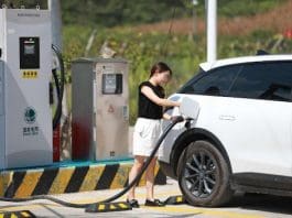 A new energy vehicle (NEV) owner charges her car at a local station in Xiamadong village, Badong county, Enshi Tujia and Miao autonomous prefecture, central China's Hubei province. (Photo by Jiao Guobin/People's Daily Online)