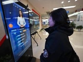At a government service center in Shenyang, northeast China's Liaoning province, a woman interacts with an AI-driven service terminal designed to streamline administrative processes. (Photo by Zhao Jingdong/People's Daily Online)