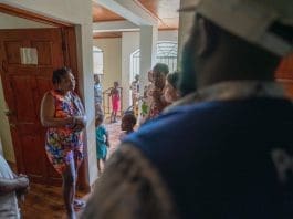 IOM staff discussing with a recently deported pregnant woman to assess her needs and listen to her story. Photo: IOM/Antoine Lemonnier