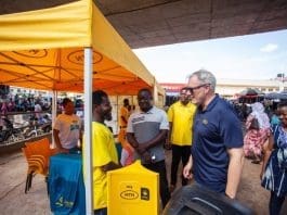 Ceo Stephen Blewett Interacts With A Vendor In Tamale Market