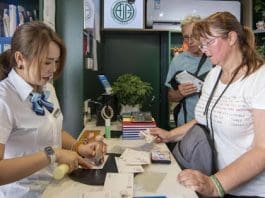 A foreign tourist mails postcards in a post office on the ancient city wall of Xi'an, northwest China's Shaanxi province, June 19, 2025. (Photo by Weng Qiyu/People's Daily Online)